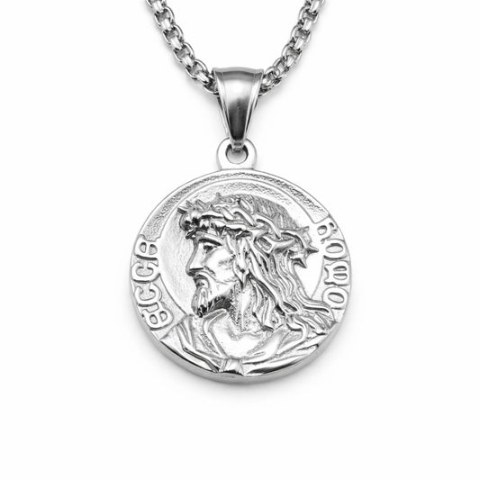 Silver pendant with a religious design on a white background