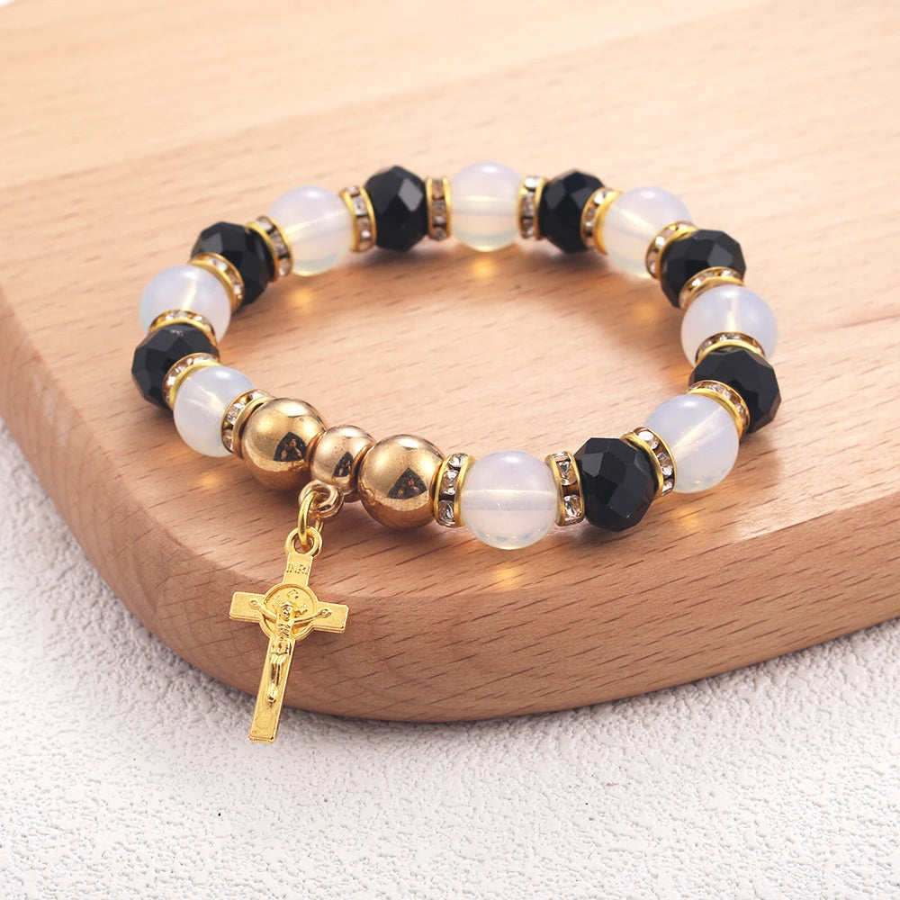 Bracelet with black, white, and gold beads on a wooden surface