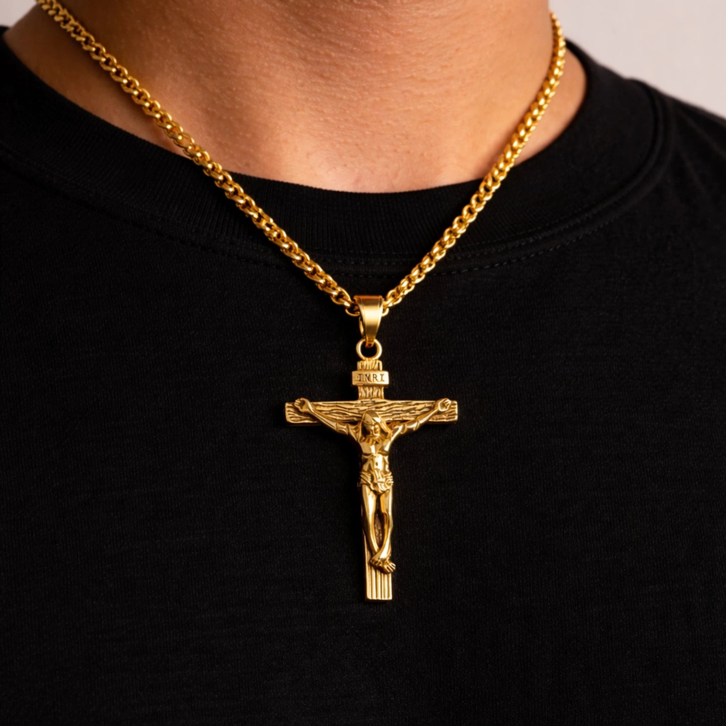Gold crucifix necklace on a black shirt