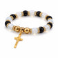 Bracelet with black, white, and gold beads on a white background