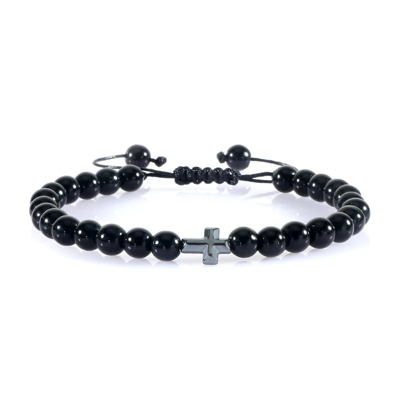 Black beaded bracelet with a silver cross charm on a white background