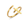 Gold ring with cross design on a white background