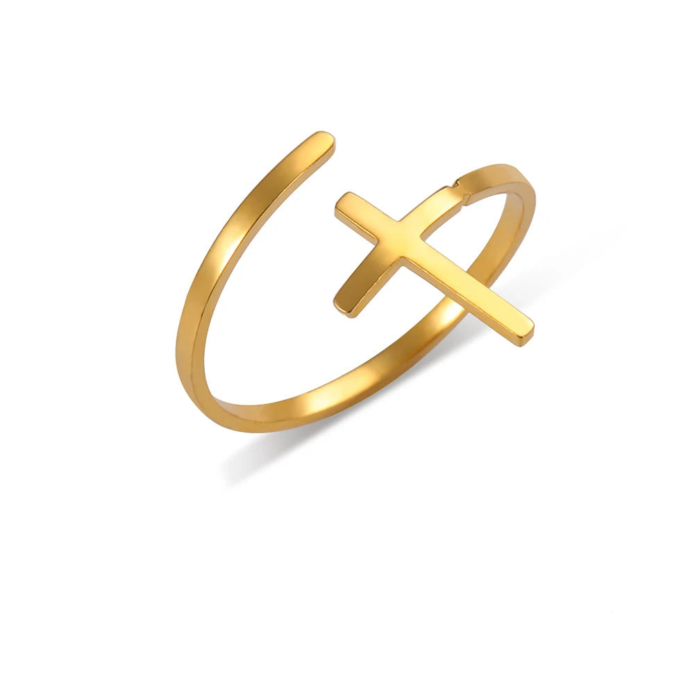 Gold ring with cross design on a white background