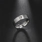 Silver ring with a cross on a dark textured background