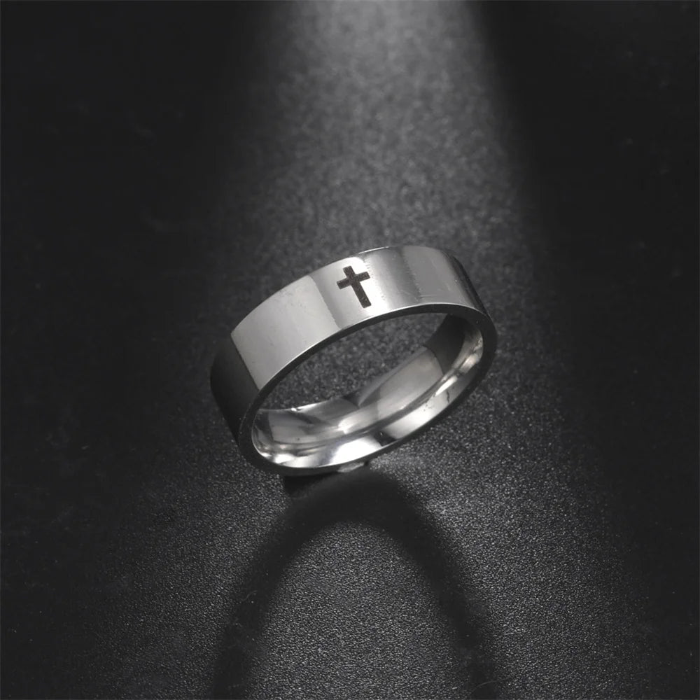 Silver ring with a cross on a dark textured background