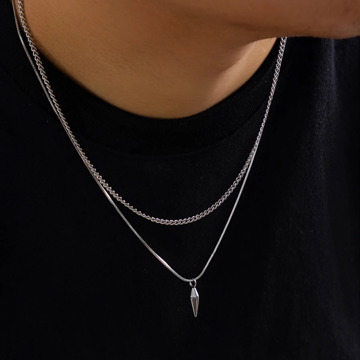 Silver necklace with a pendant on a black background